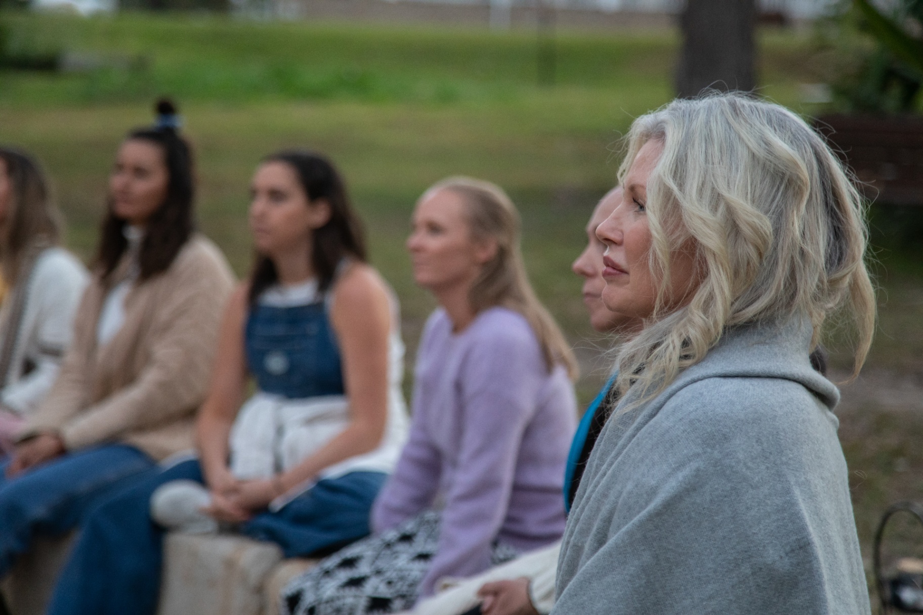 Women in quiet reflection during circle
