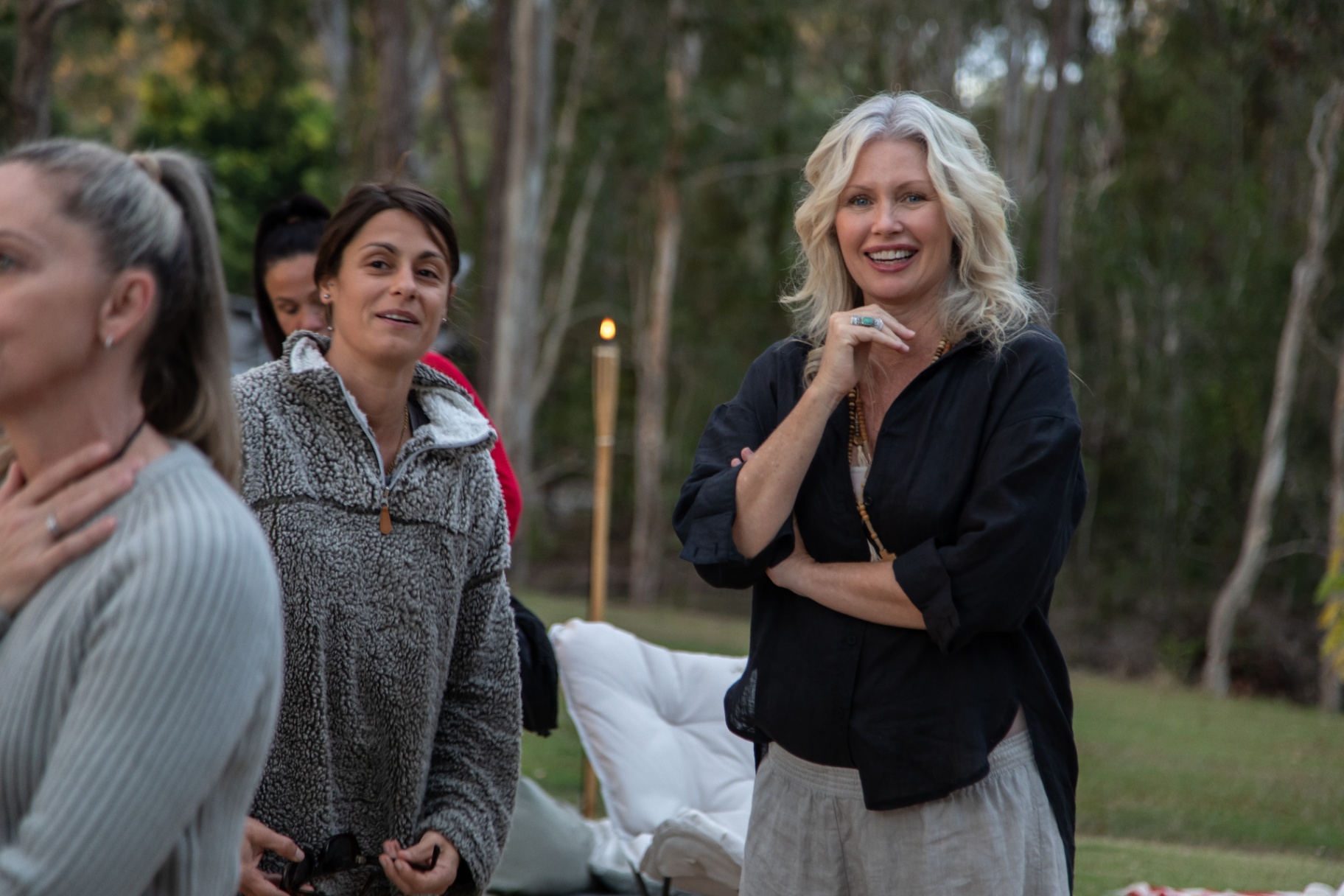 Kim smiling with women in conversation